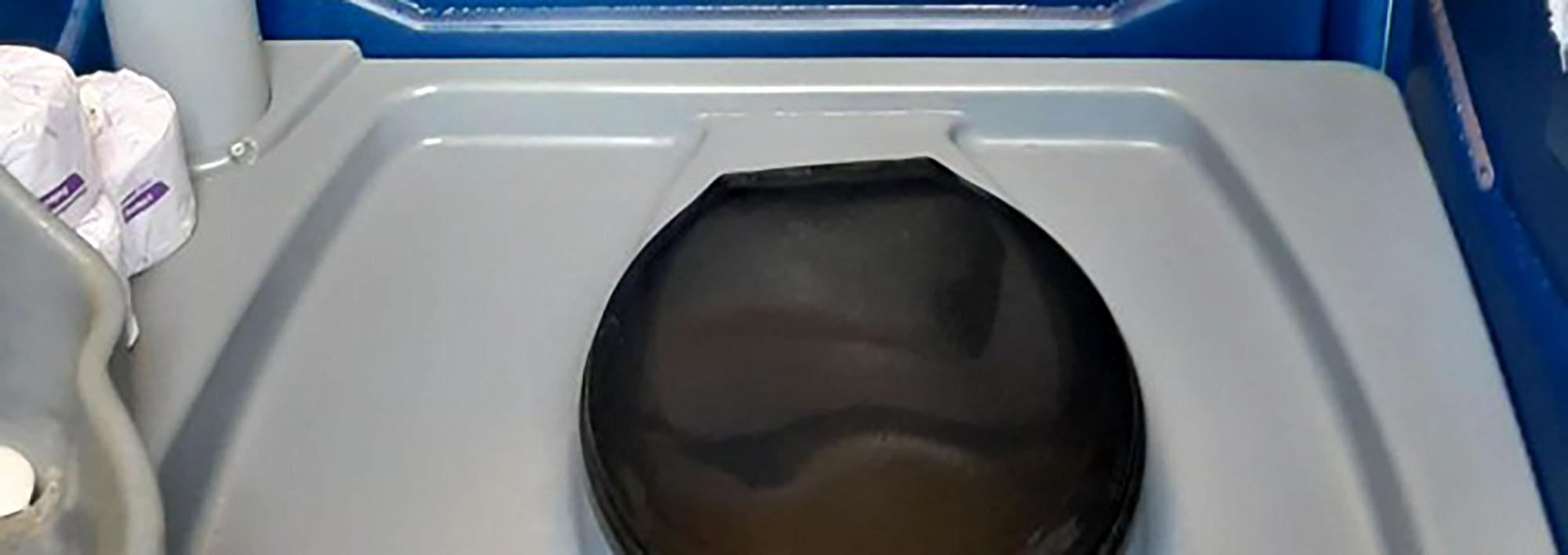 Interior of a portable toilet with open lid