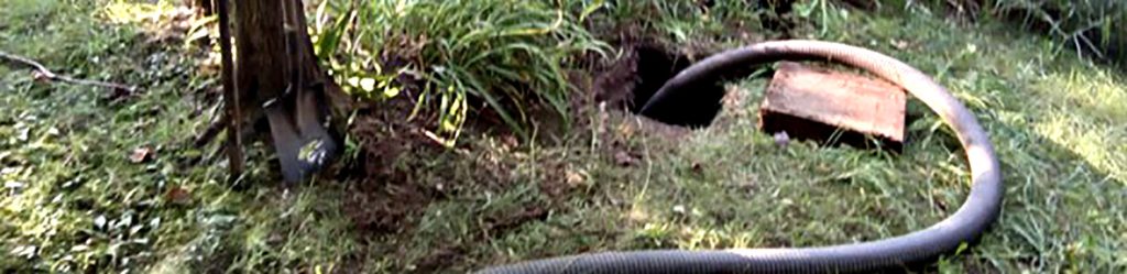 Septic Tank with drainage line maintenance in an outdoor setting with equipment