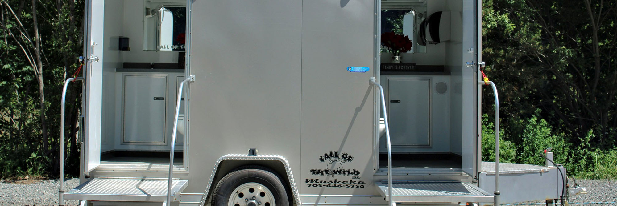 Mobile luxury restroom trailer in a forest setting