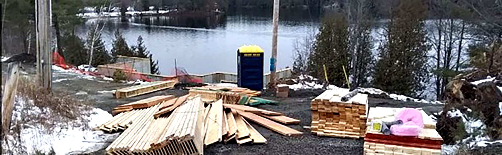 Construction materials near a frozen lake in winter setting