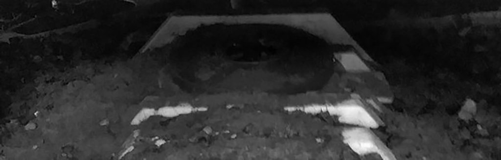 Septic tank with circular opening;in dim lighting