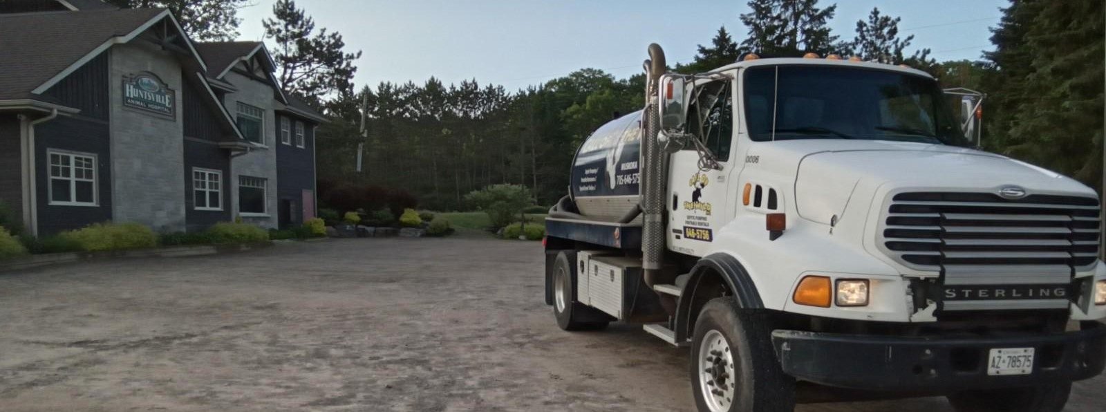 Septic service truck parked outside Mainline Mechanical building